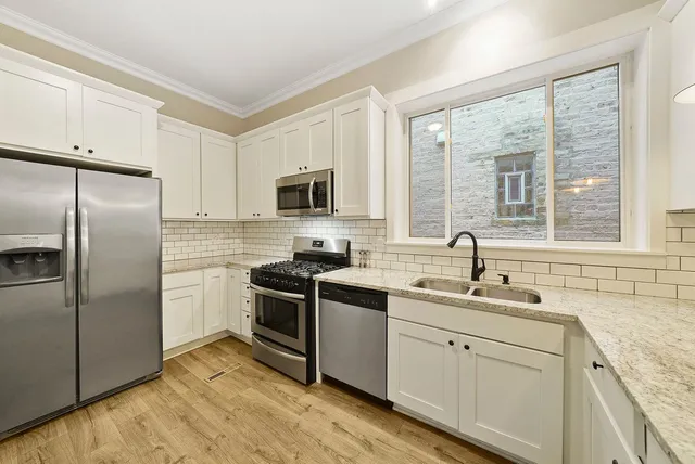 a kitchen with a sink stove and refrigerator