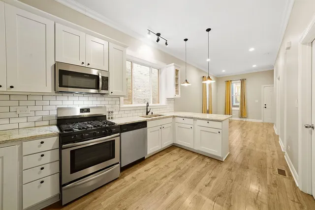 a kitchen with a stove a sink and a microwave