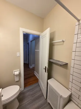 a bathroom with a toilet and a shower