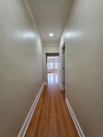 a view of gallery with wooden floor