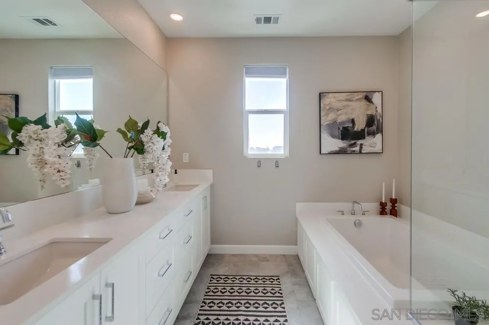 1956 Infinity Lane Chula Vista, CA 91915 - Photo 14 of 58 a bathroom with a tub sink and mirror