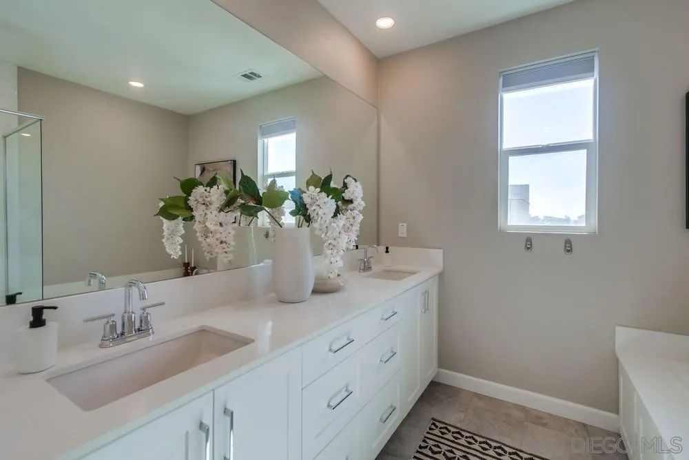 1956 Infinity Lane Chula Vista, CA 91915 - Photo 15 of 58 a bathroom with double vanity and a mirror