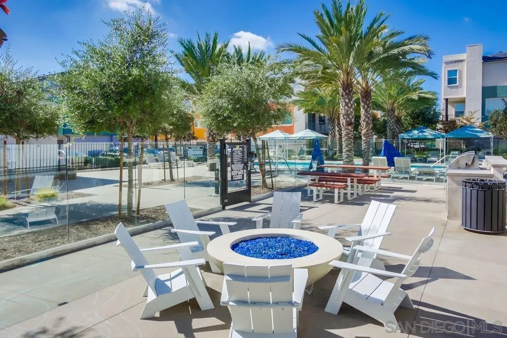 1956 Infinity Lane Chula Vista, CA 91915 - Photo 31 of 58 a view of a patio with table and chairs potted plants and palm tree