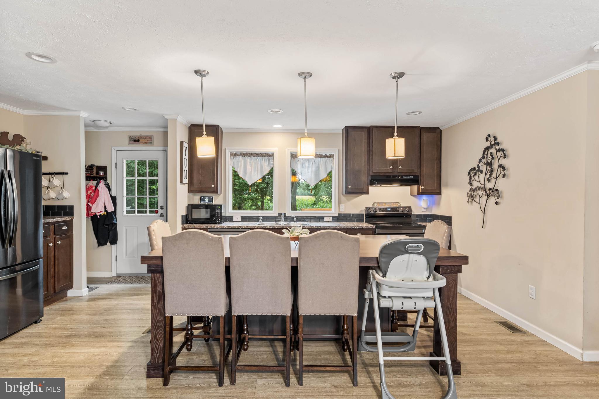 24335 Shortly Road Georgetown, DE 19947 - Photo 11 of 29 a dining room with furniture a chandelier and window
