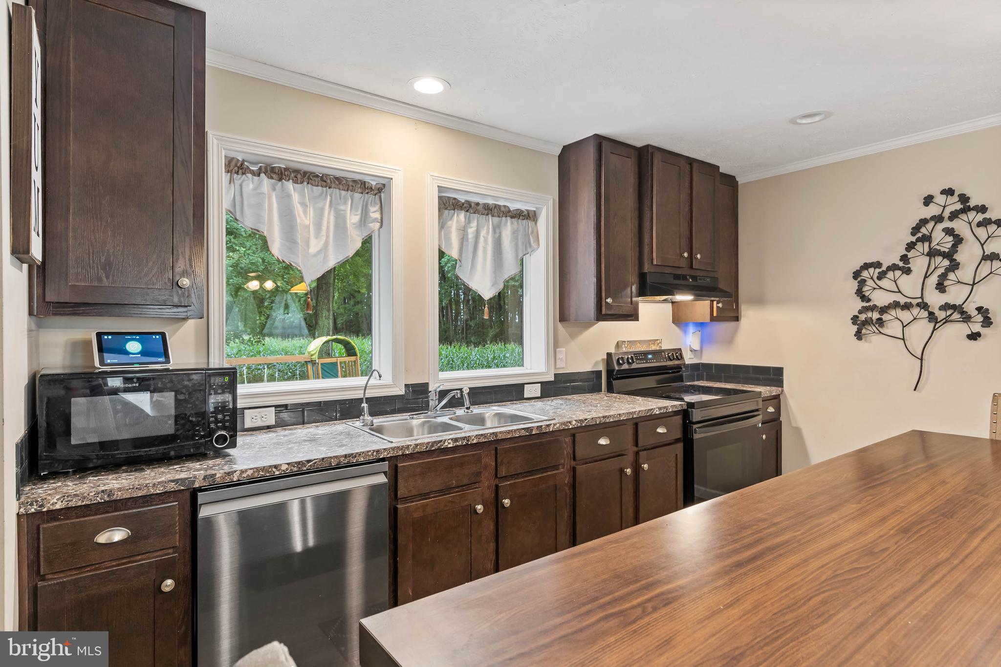 24335 Shortly Road Georgetown, DE 19947 - Photo 12 of 29 a kitchen with stainless steel appliances granite countertop a sink stove and oven
