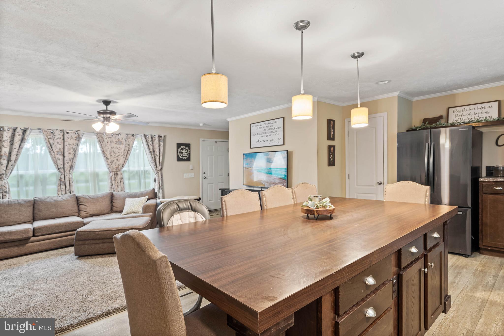 24335 Shortly Road Georgetown, DE 19947 - Photo 14 of 29 a dining room with stainless steel appliances granite countertop a table chairs and couches