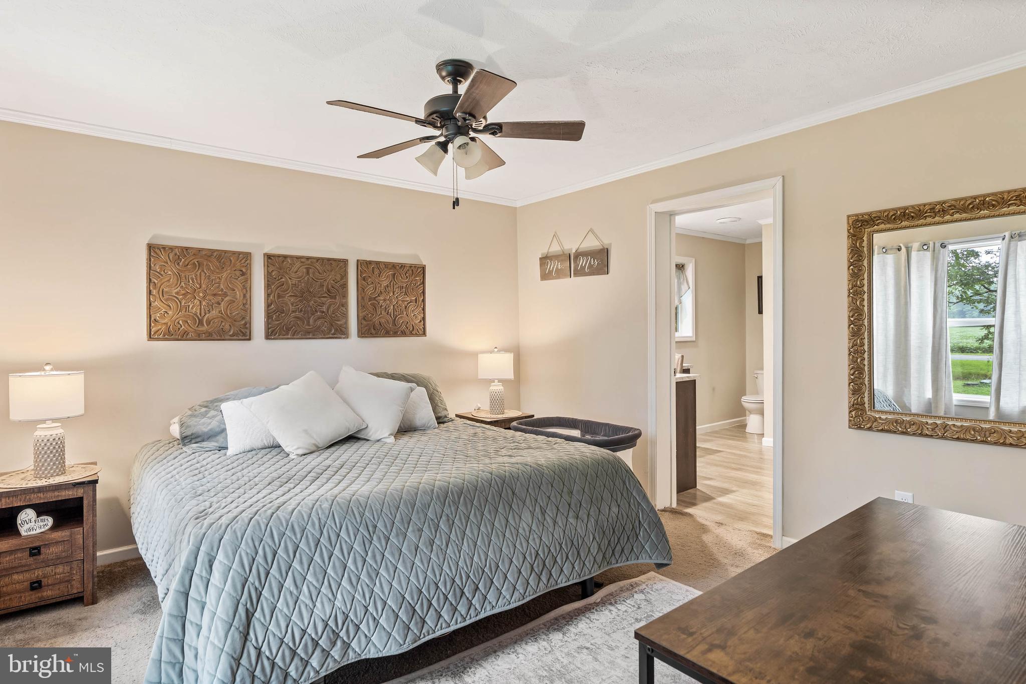 24335 Shortly Road Georgetown, DE 19947 - Photo 15 of 29 a bedroom with a large bed and a chandelier