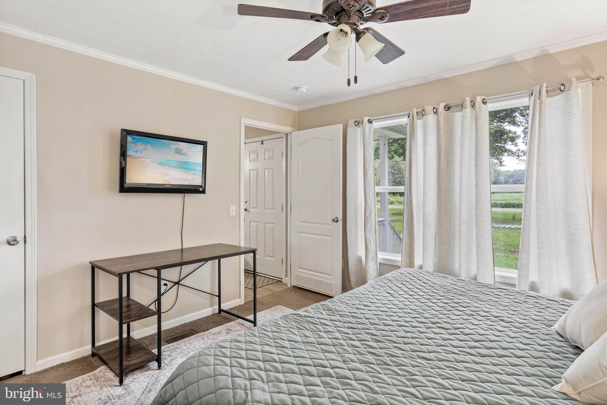 24335 Shortly Road Georgetown, DE 19947 - Photo 17 of 29 a bedroom with a bed and a chandelier