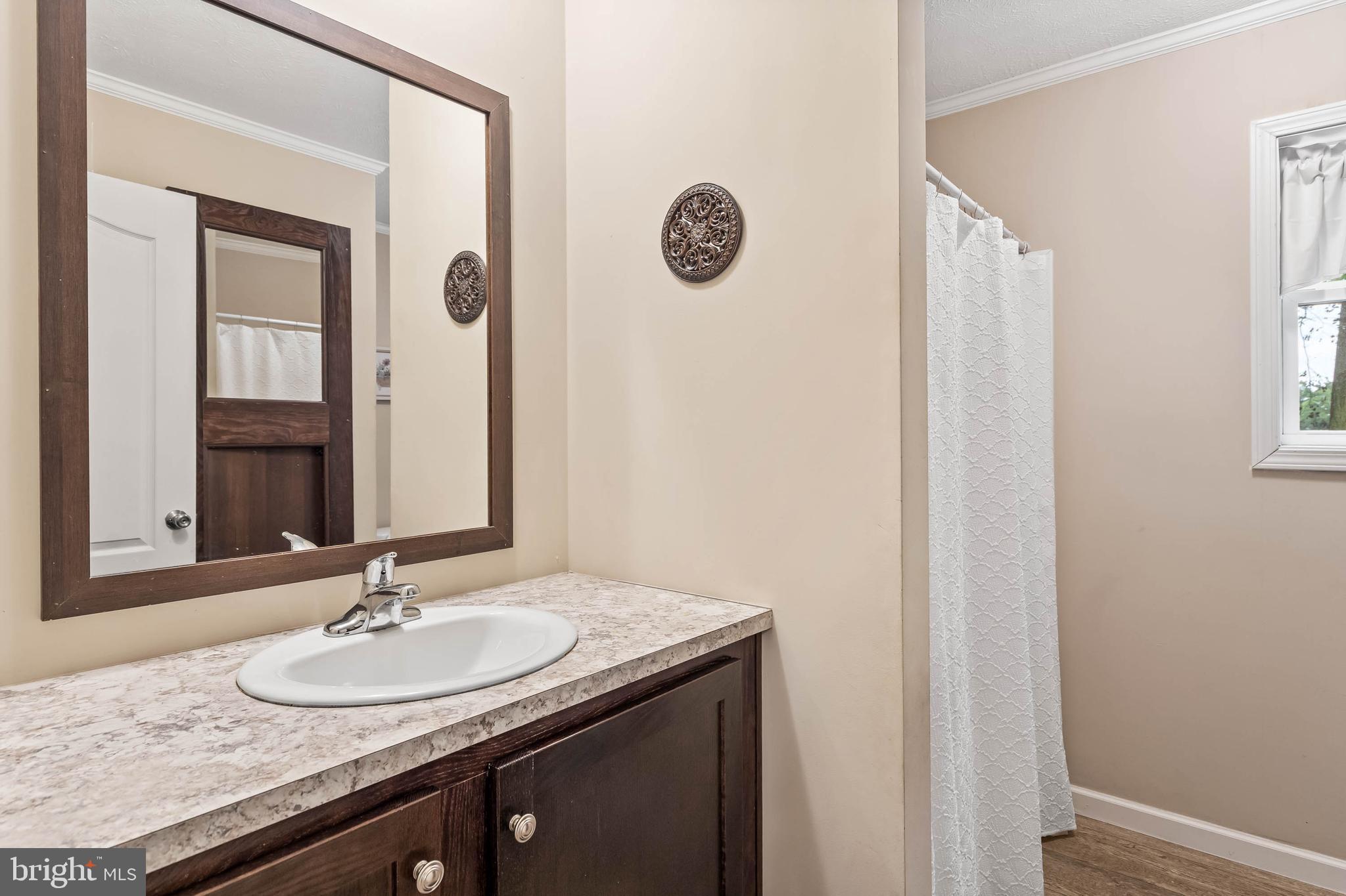 24335 Shortly Road Georgetown, DE 19947 - Photo 23 of 29 a bathroom with a granite countertop sink and a mirror