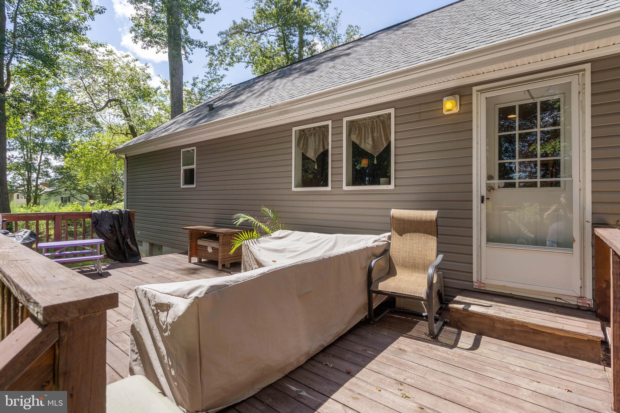 24335 Shortly Road Georgetown, DE 19947 - Photo 26 of 29 a view of a patio with table and chairs with wooden floor and fence and a barbeque grill