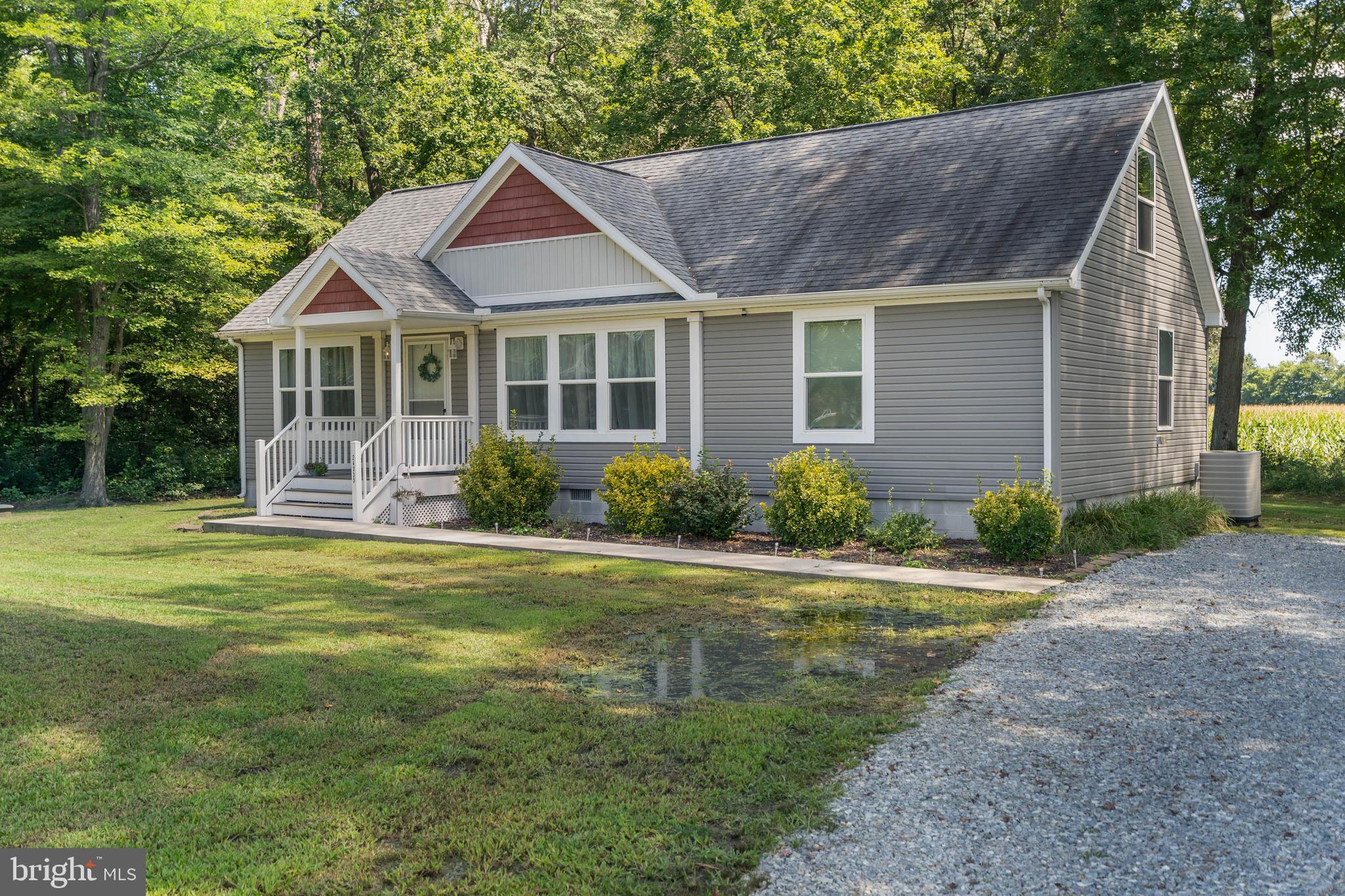 24335 Shortly Road Georgetown, DE 19947 - Photo 3 of 29 a front view of a house with a garden