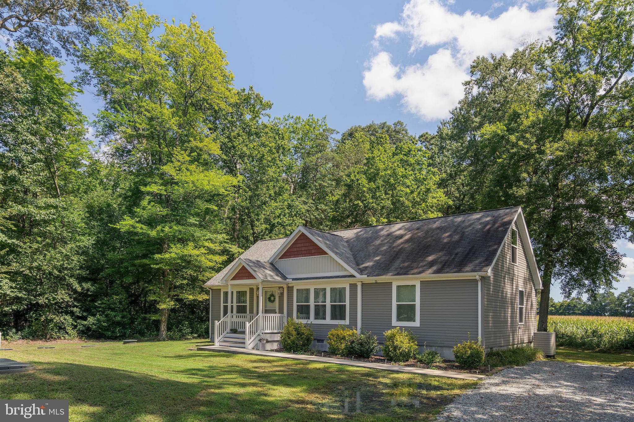 24335 Shortly Road Georgetown, DE 19947 - Photo 4 of 29 a front view of a house with a garden