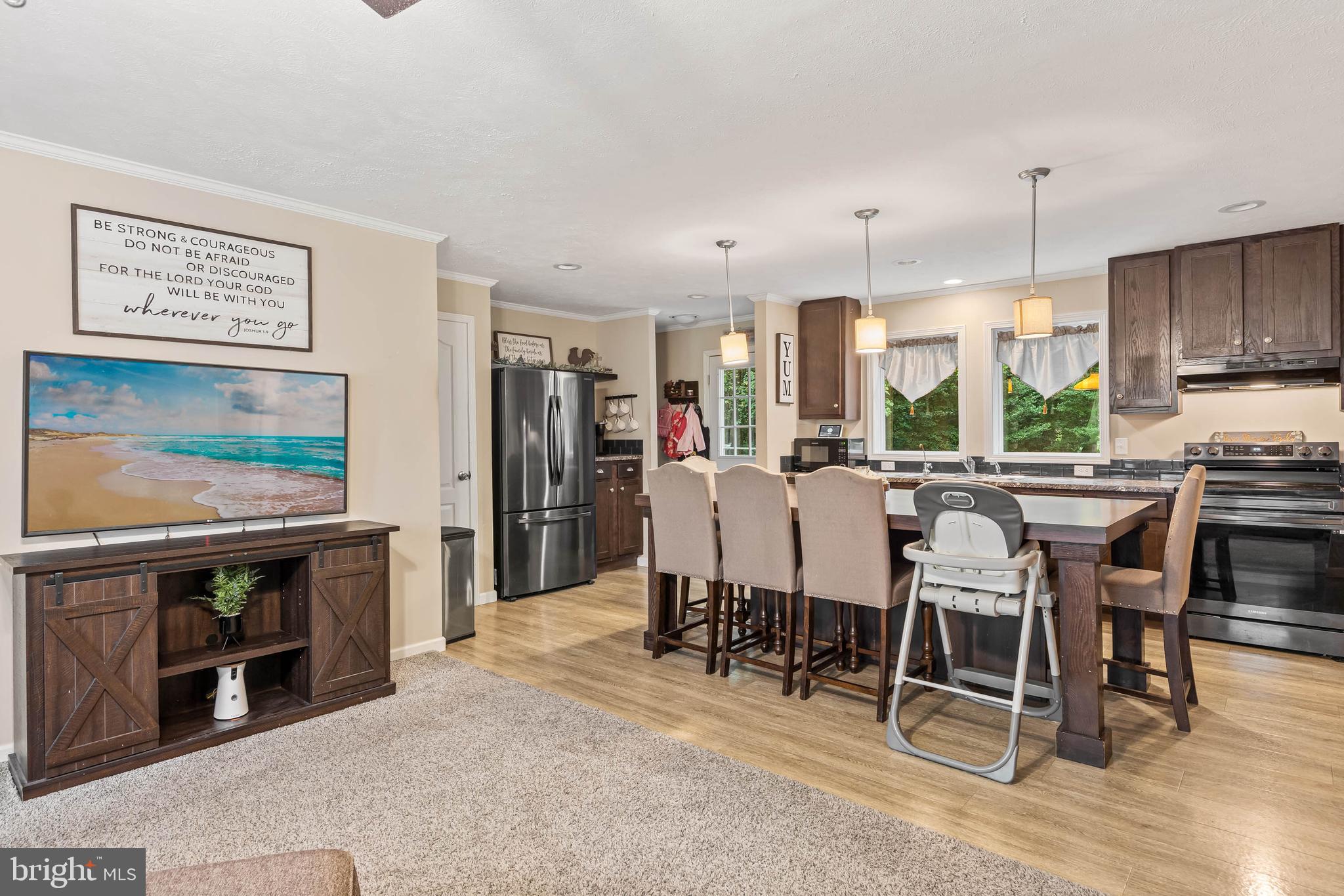 24335 Shortly Road Georgetown, DE 19947 - Photo 8 of 29 a kitchen with stainless steel appliances kitchen island granite countertop a table chairs sink and cabinets