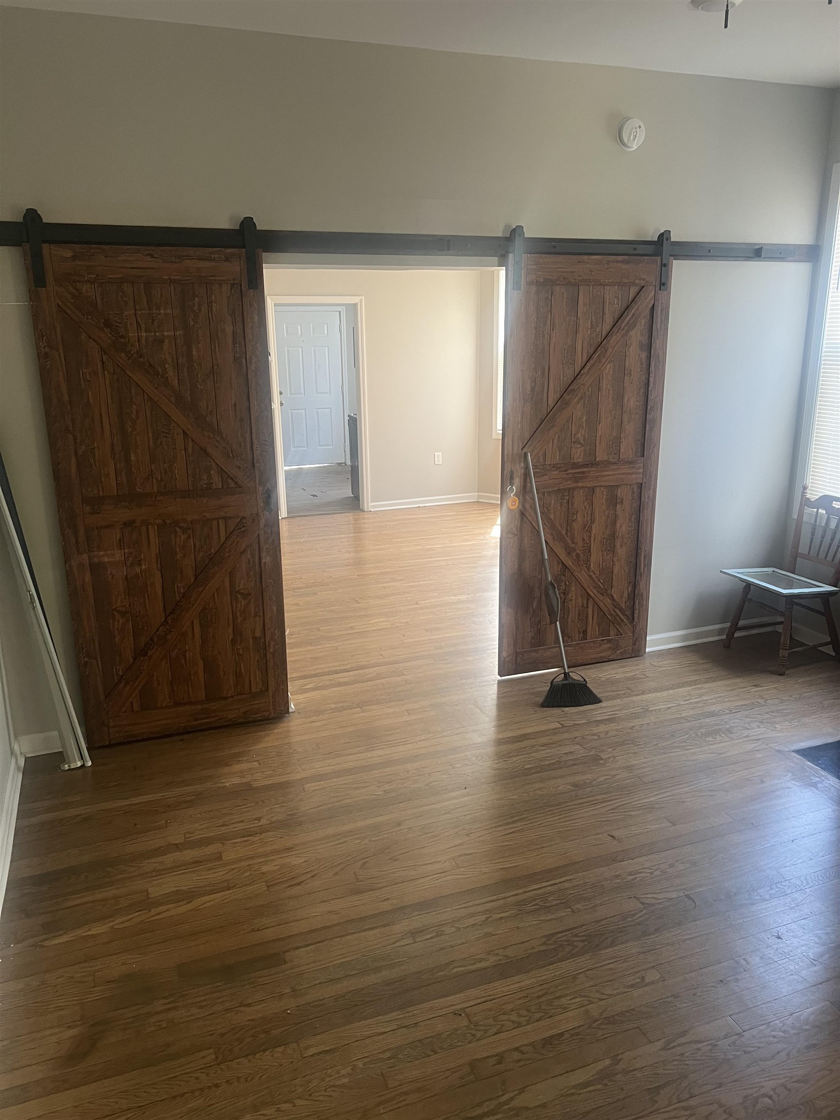 1353 Harbert Avenue Memphis, TN 38104 - Photo 6 of 18 a view of an empty room with wooden floor and windows