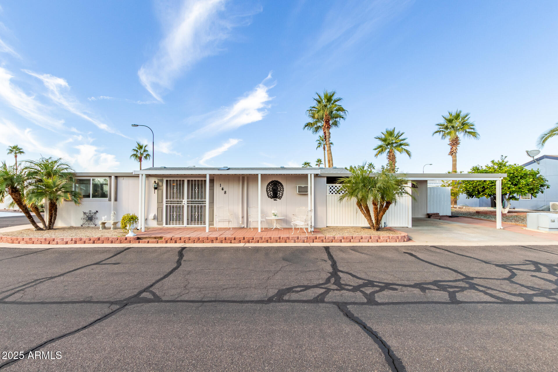 2400 East Baseline Avenue, Unit 148 Apache Junction, AZ 85119 - Photo 1 of 42 front view of a house with a patio