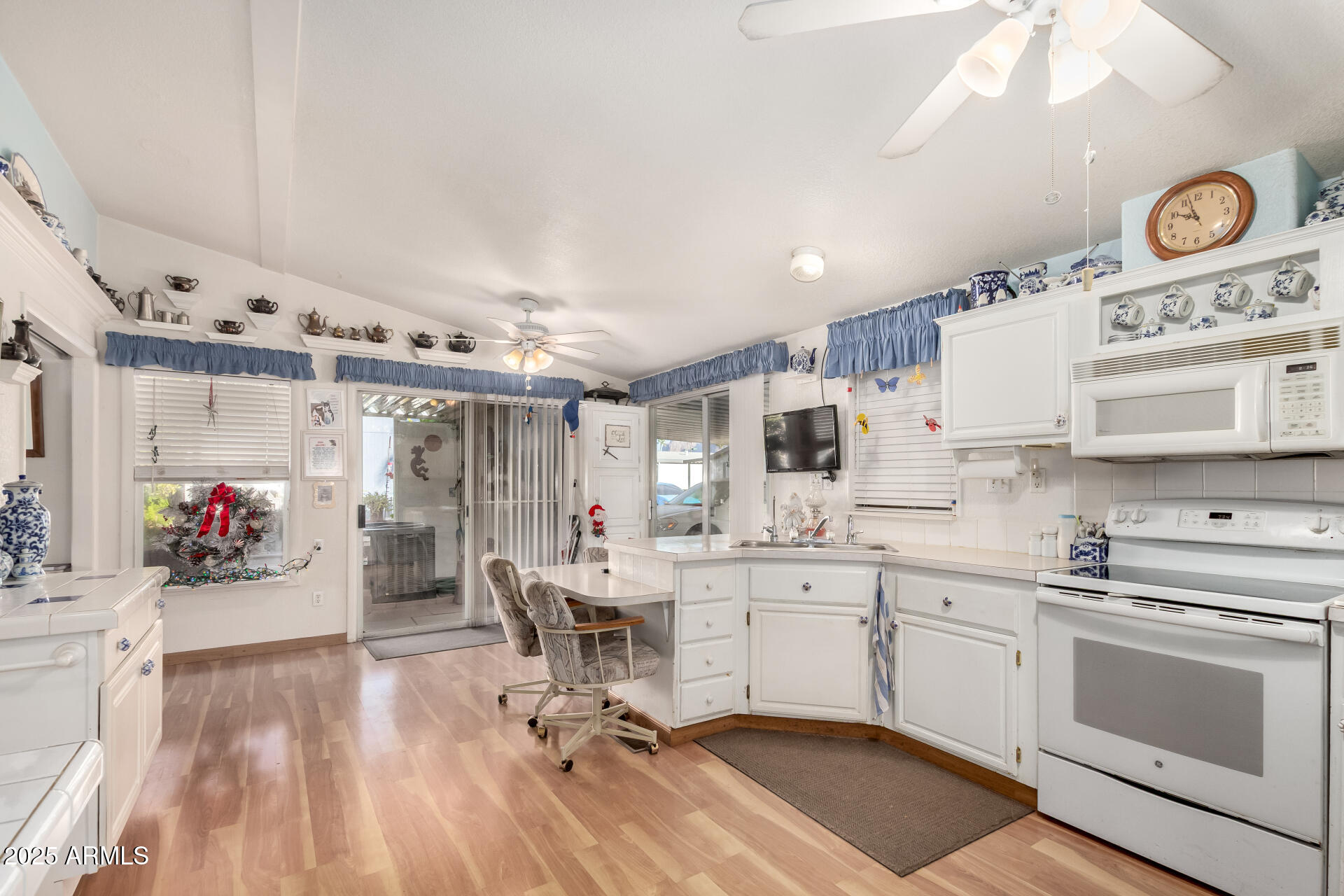 2400 East Baseline Avenue, Unit 148 Apache Junction, AZ 85119 - Photo 12 of 42 a kitchen that has a lot of cabinets in it and wooden floors