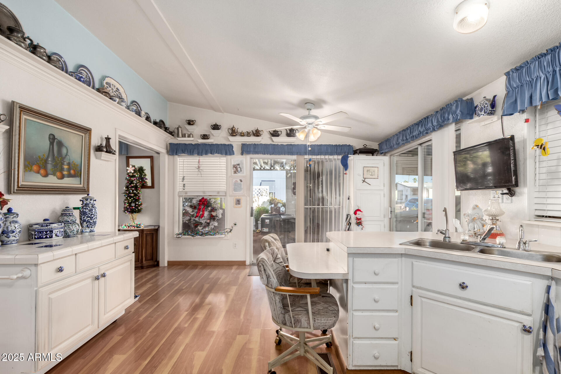 2400 East Baseline Avenue, Unit 148 Apache Junction, AZ 85119 - Photo 13 of 42 a large white kitchen with a lot of counter space and wooden floor