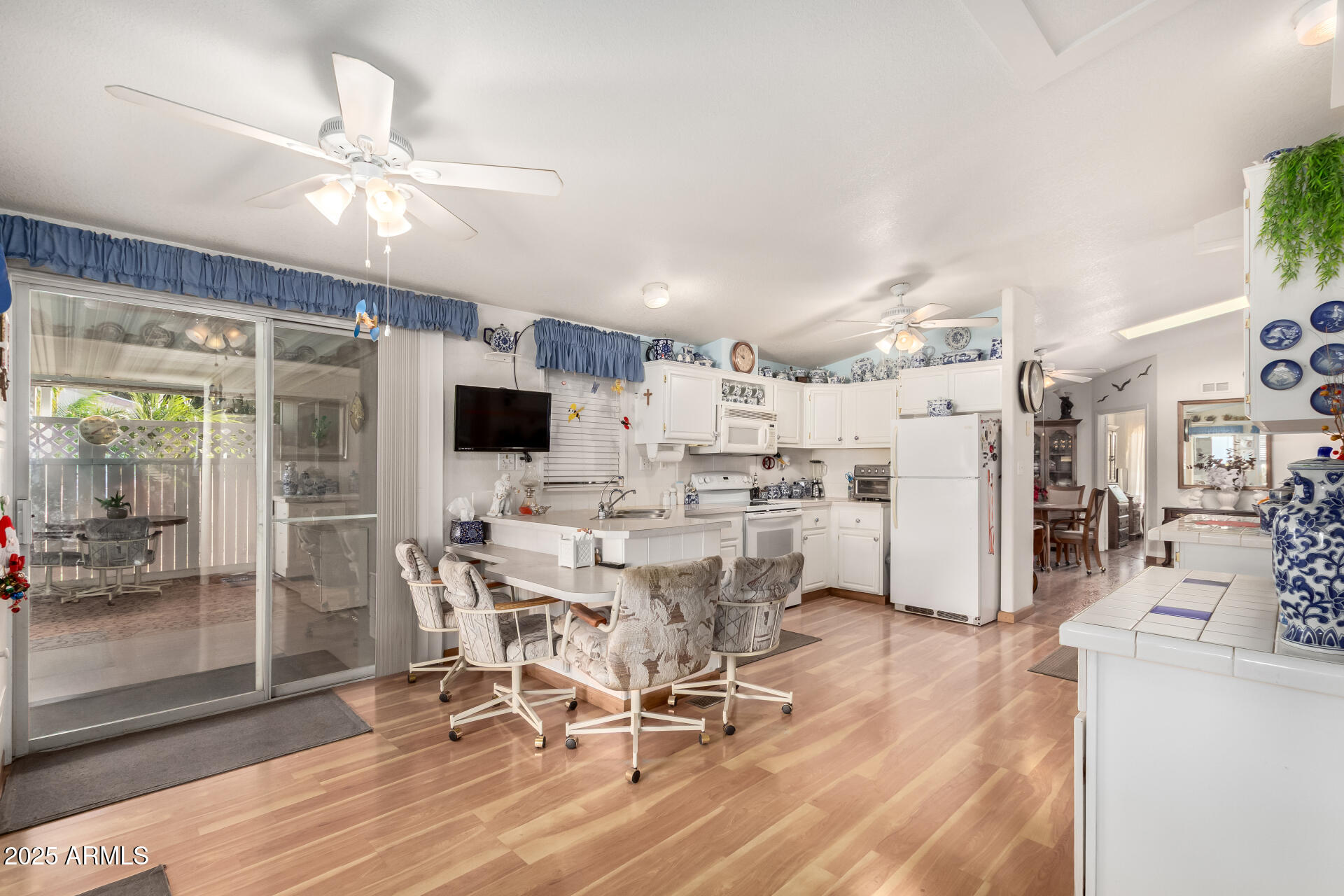 2400 East Baseline Avenue, Unit 148 Apache Junction, AZ 85119 - Photo 14 of 42 a view of a dining room with furniture window and wooden floor