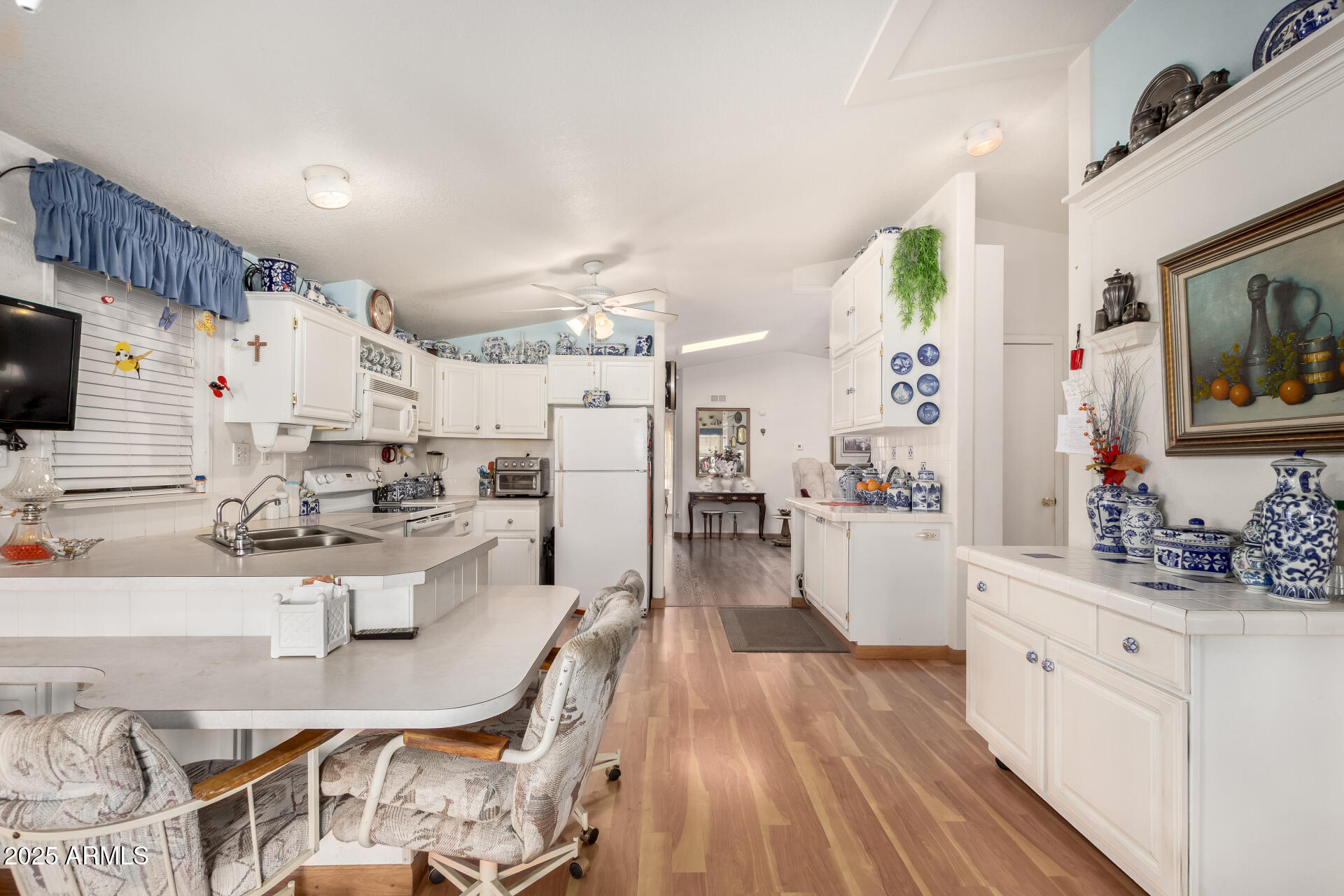 2400 East Baseline Avenue, Unit 148 Apache Junction, AZ 85119 - Photo 15 of 42 a large white kitchen with lots of counter space and view of living room