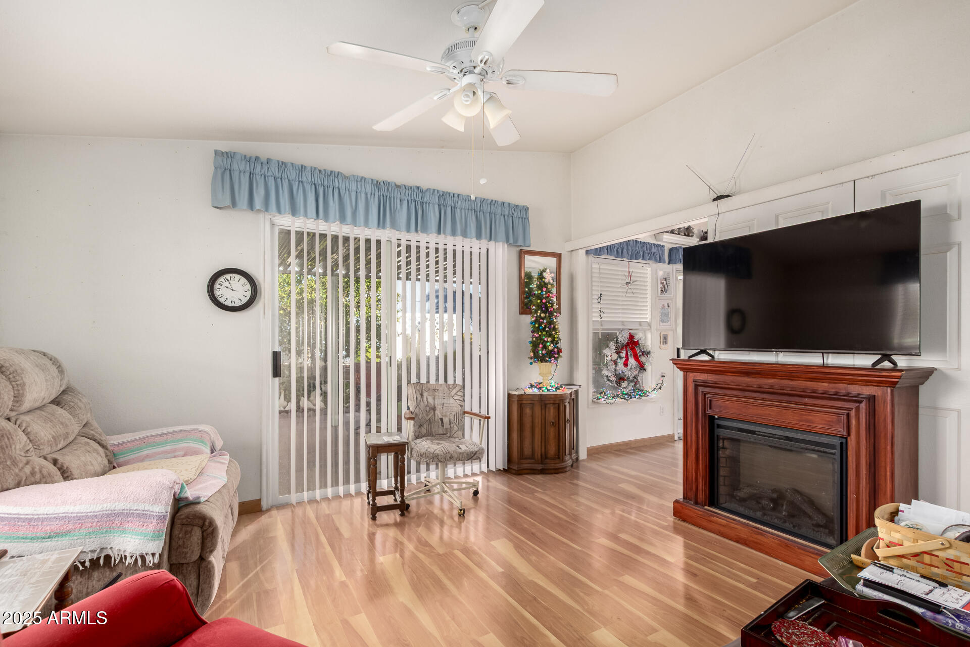 2400 East Baseline Avenue, Unit 148 Apache Junction, AZ 85119 - Photo 18 of 42 a living room with furniture a flat screen tv and a fireplace