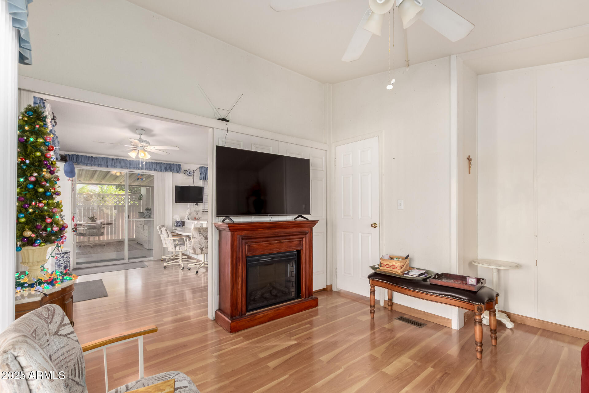 2400 East Baseline Avenue, Unit 148 Apache Junction, AZ 85119 - Photo 19 of 42 a living room with furniture a flat screen tv and a fireplace