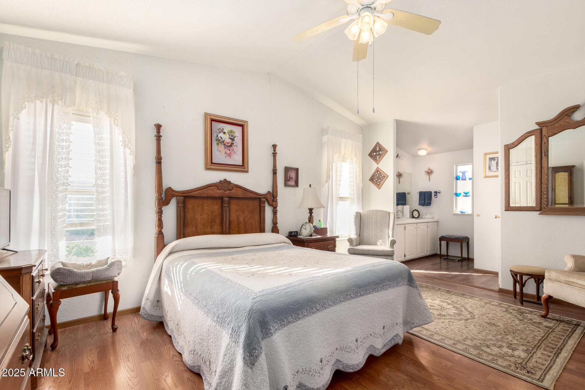 2400 East Baseline Avenue, Unit 148 Apache Junction, AZ 85119 - Photo 20 of 42 a bedroom with a bed and a chandelier