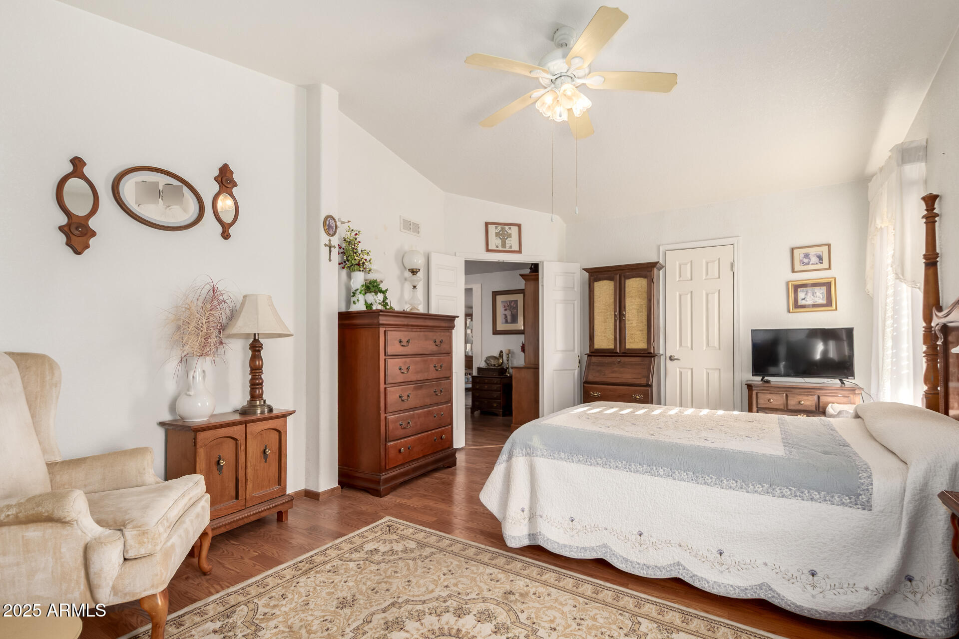 2400 East Baseline Avenue, Unit 148 Apache Junction, AZ 85119 - Photo 22 of 42 a spacious bedroom with a bed a dresser and potted plant
