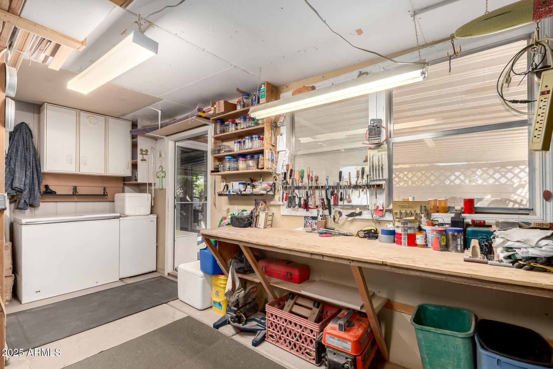 2400 East Baseline Avenue, Unit 148 Apache Junction, AZ 85119 - Photo 30 of 42 a room with stainless steel appliances kitchen island granite countertop a sink and cabinets