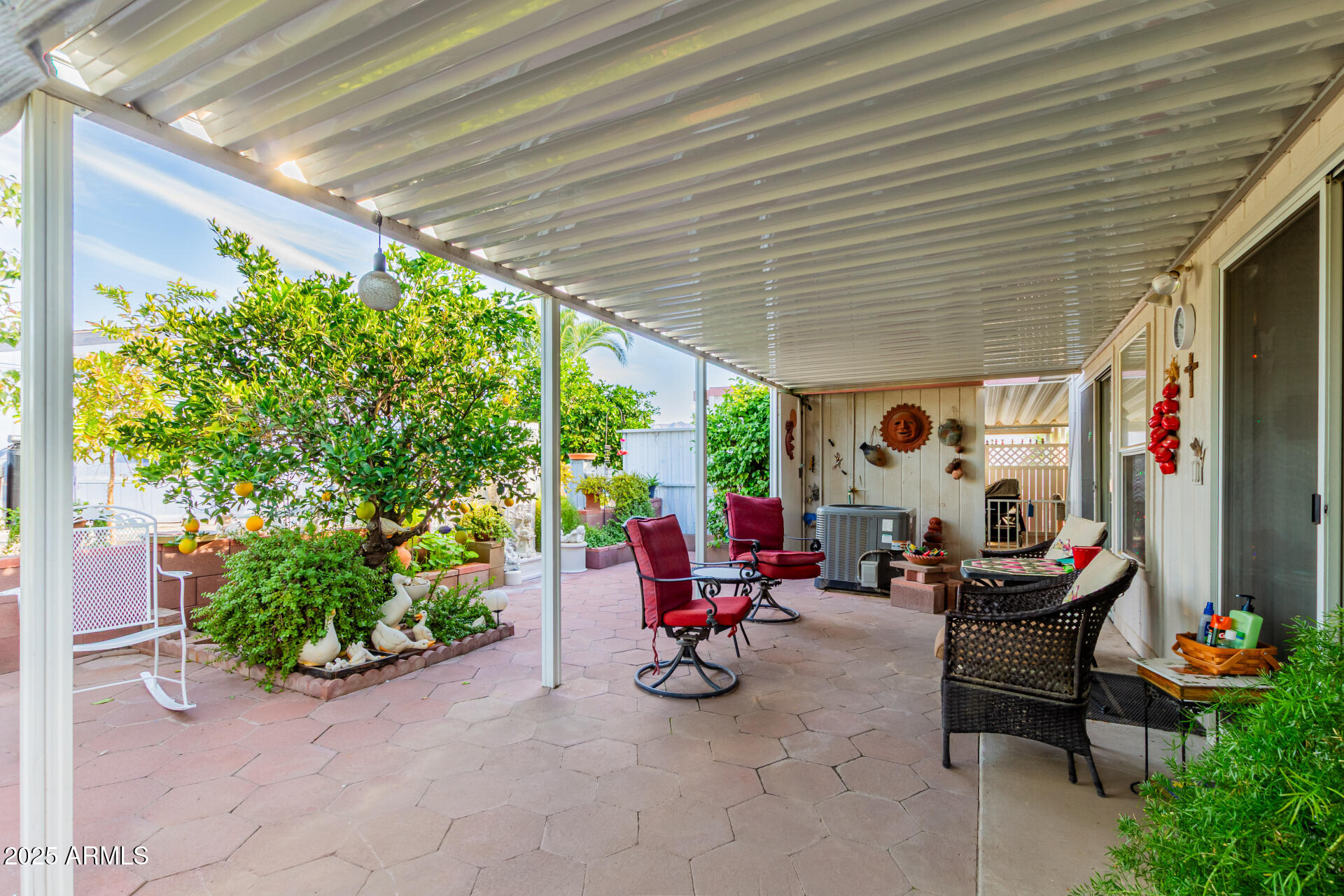 2400 East Baseline Avenue, Unit 148 Apache Junction, AZ 85119 - Photo 33 of 42 a view of a chairs and tables in patio with potted plants