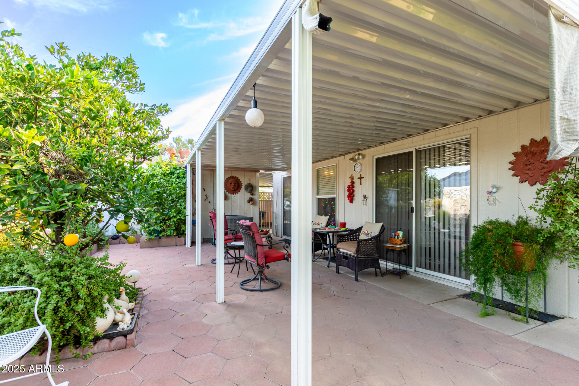 2400 East Baseline Avenue, Unit 148 Apache Junction, AZ 85119 - Photo 34 of 42 a view of a patio with table and chairs and potted plants