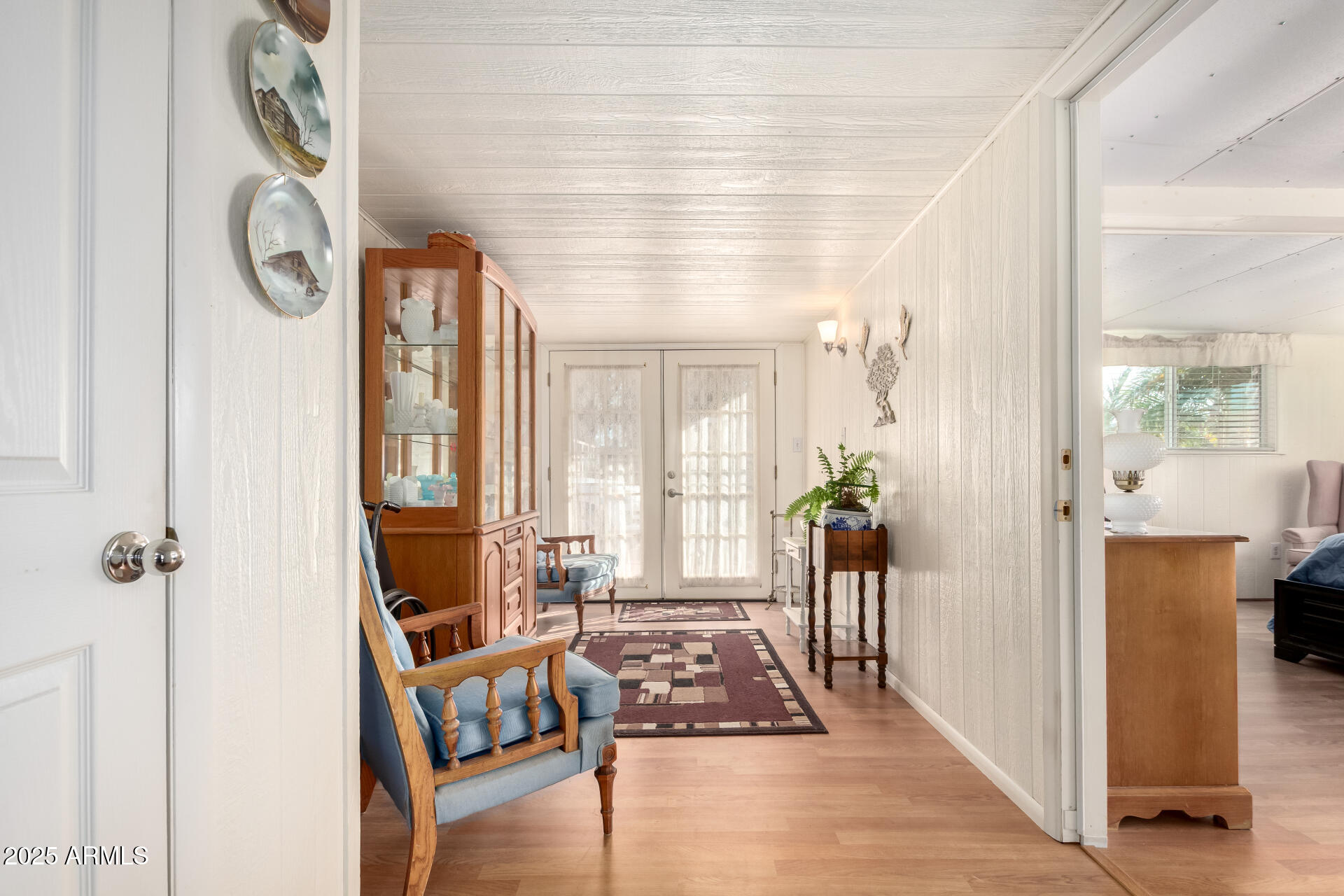 2400 East Baseline Avenue, Unit 148 Apache Junction, AZ 85119 - Photo 8 of 42 a view of a hallway to a livingroom with furniture wooden floor and windows