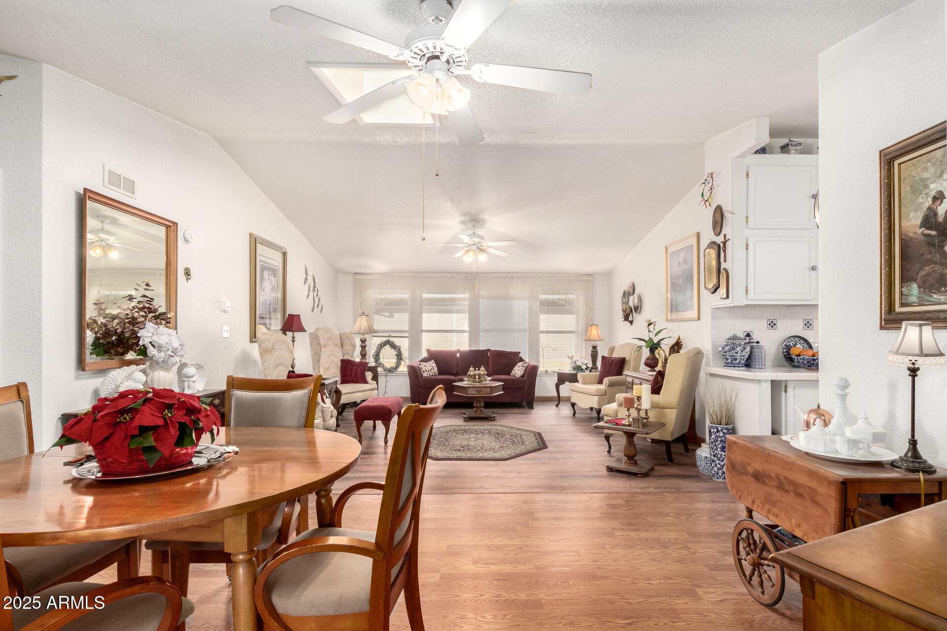 2400 East Baseline Avenue, Unit 148 Apache Junction, AZ 85119 - Photo 10 of 42 a living room with fireplace furniture and a chandelier