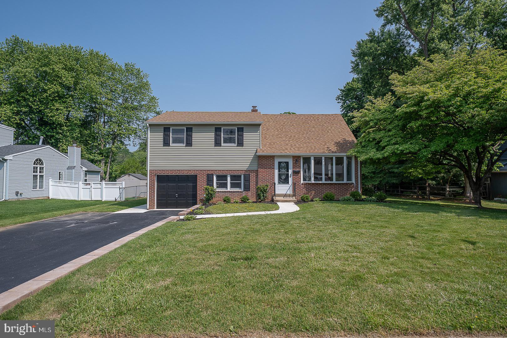 503 Poplar Road Flourtown, PA 19031 - Photo 1 of 63 a front view of a house with a garden and trees