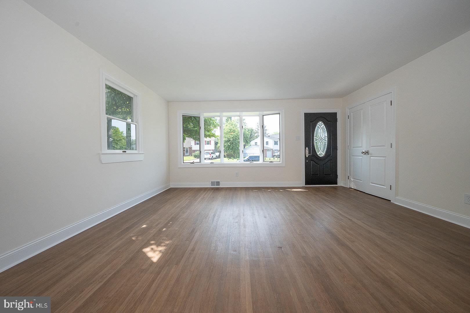 503 Poplar Road Flourtown, PA 19031 - Photo 11 of 63 an empty room with wooden floor and windows