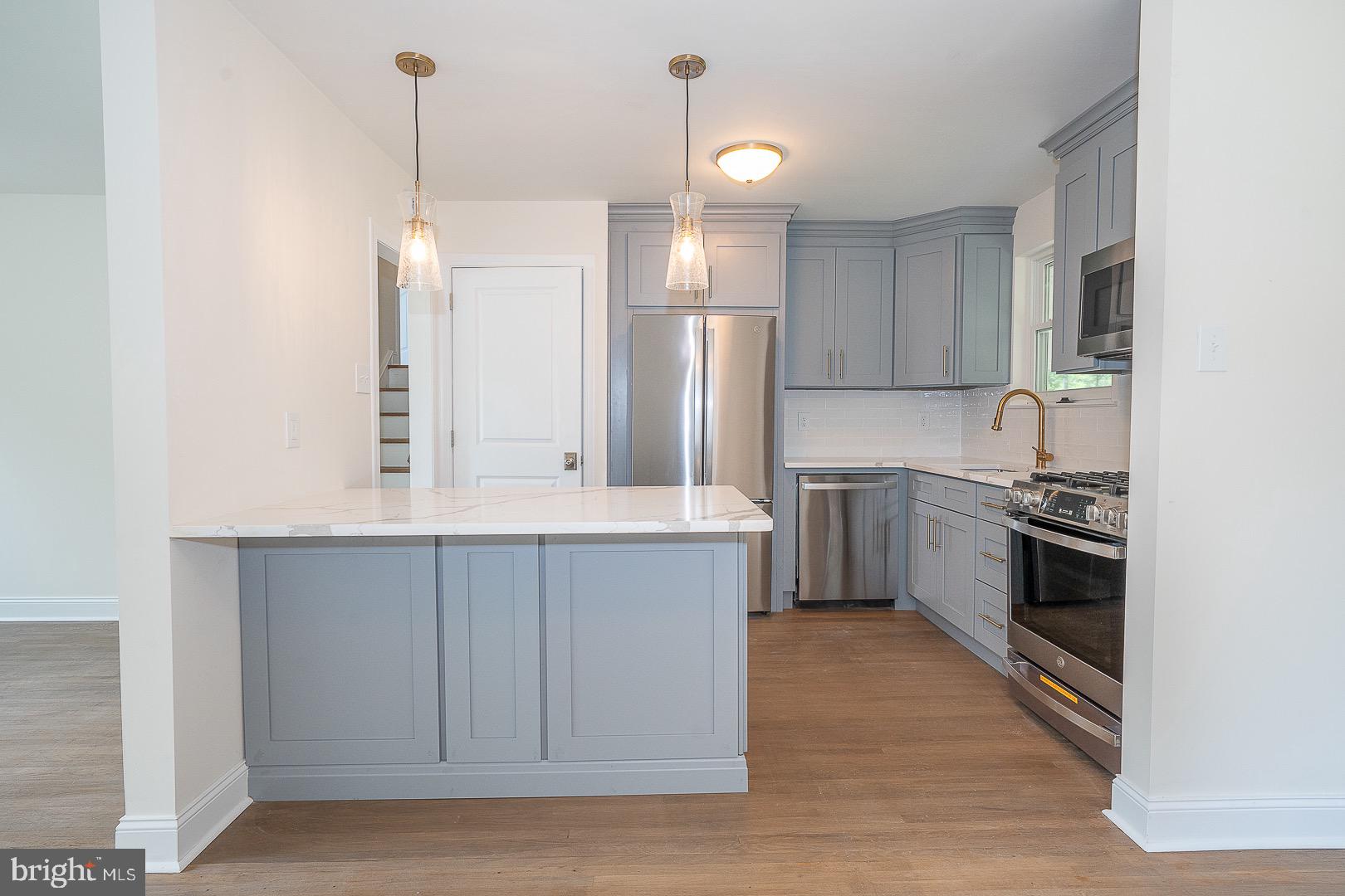 503 Poplar Road Flourtown, PA 19031 - Photo 17 of 63 a kitchen with kitchen island a sink appliances and cabinets