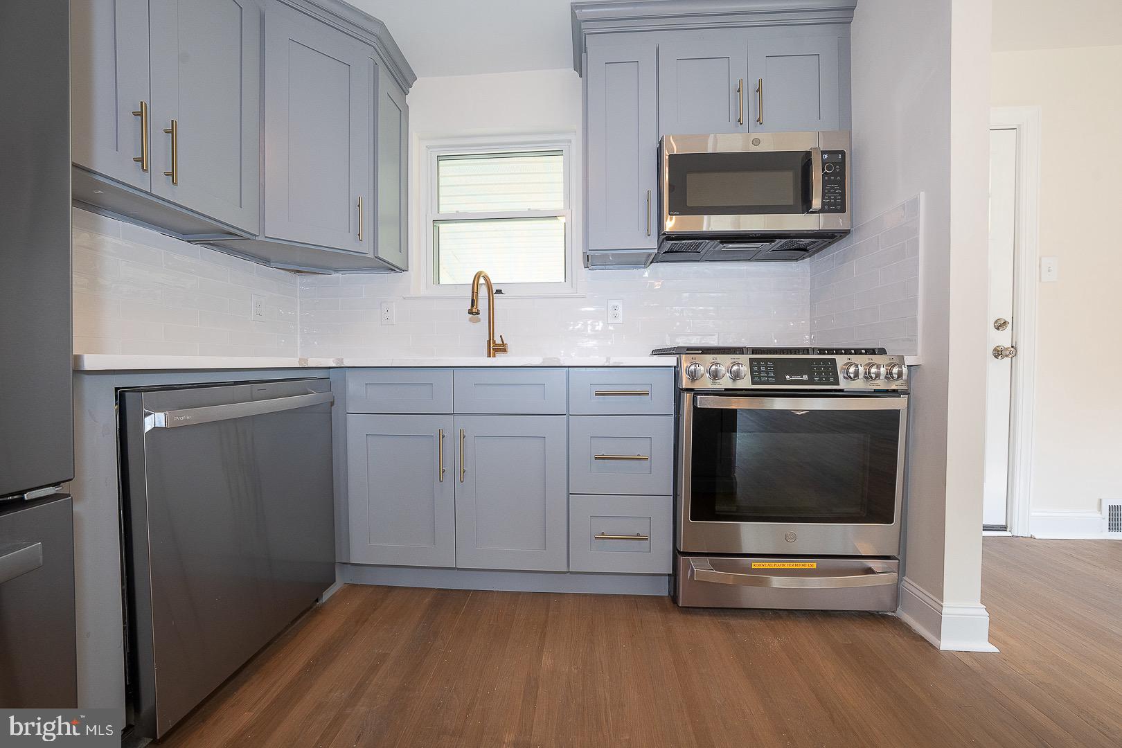 503 Poplar Road Flourtown, PA 19031 - Photo 19 of 63 a kitchen with cabinets stainless steel appliances and wooden floor