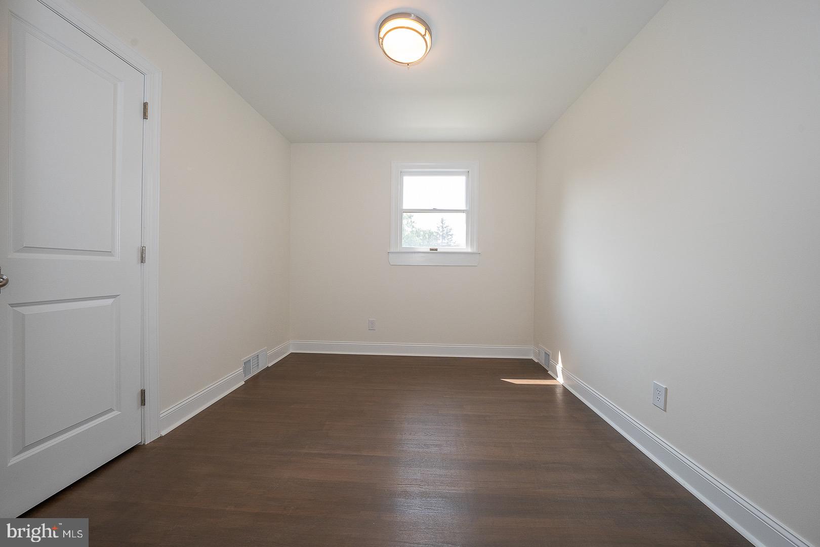 503 Poplar Road Flourtown, PA 19031 - Photo 24 of 63 an empty room with wooden floor and windows