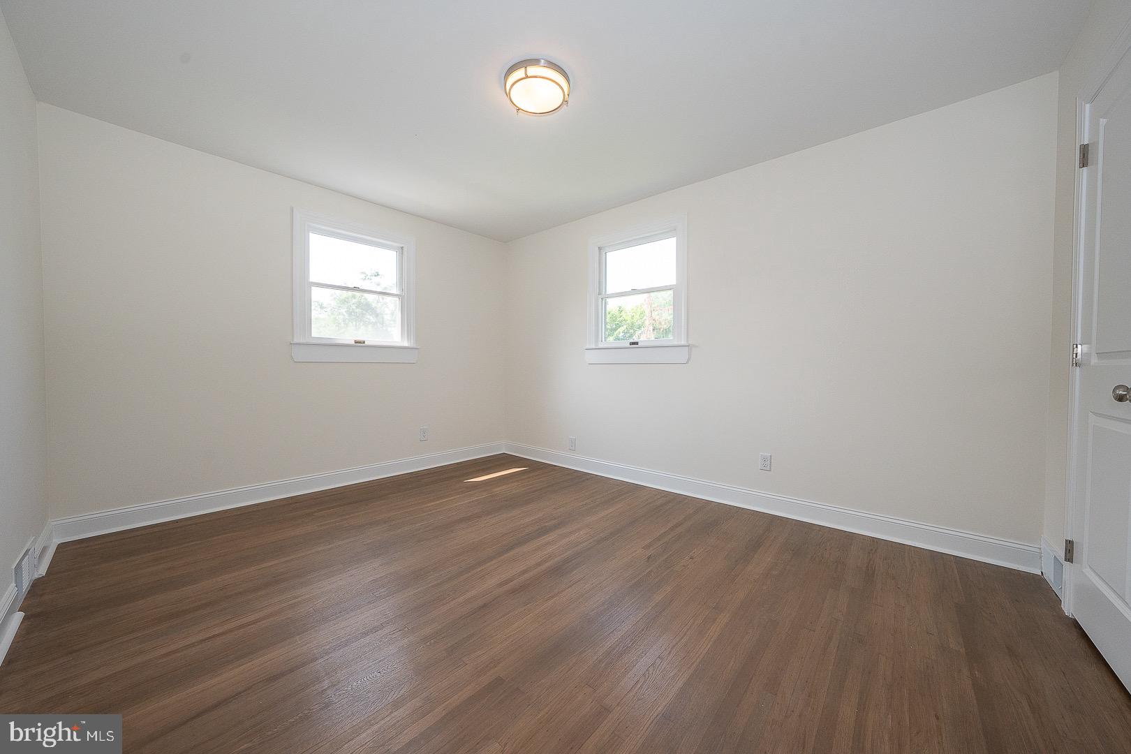 503 Poplar Road Flourtown, PA 19031 - Photo 27 of 63 a view of an empty room with wooden floor and a window