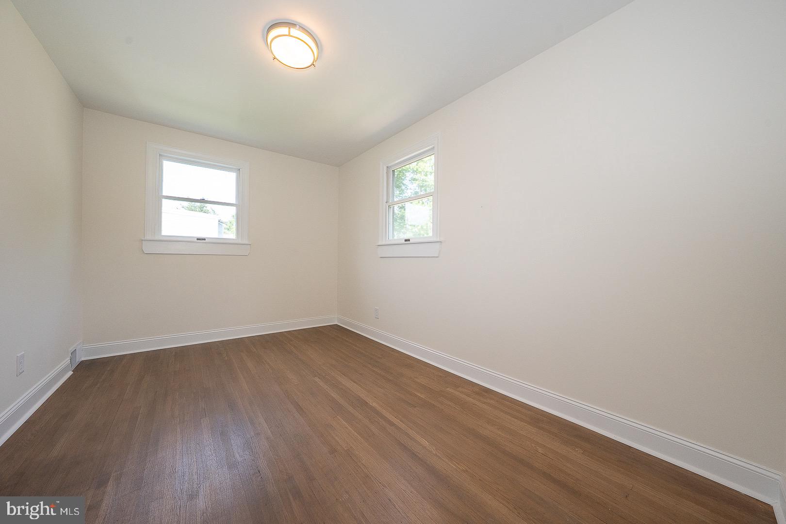 503 Poplar Road Flourtown, PA 19031 - Photo 30 of 63 an empty room with wooden floor and windows