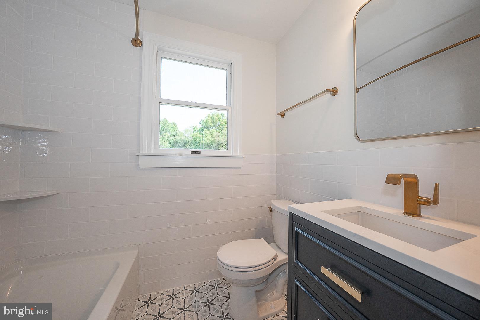 503 Poplar Road Flourtown, PA 19031 - Photo 32 of 63 a bathroom with a sink toilet and window