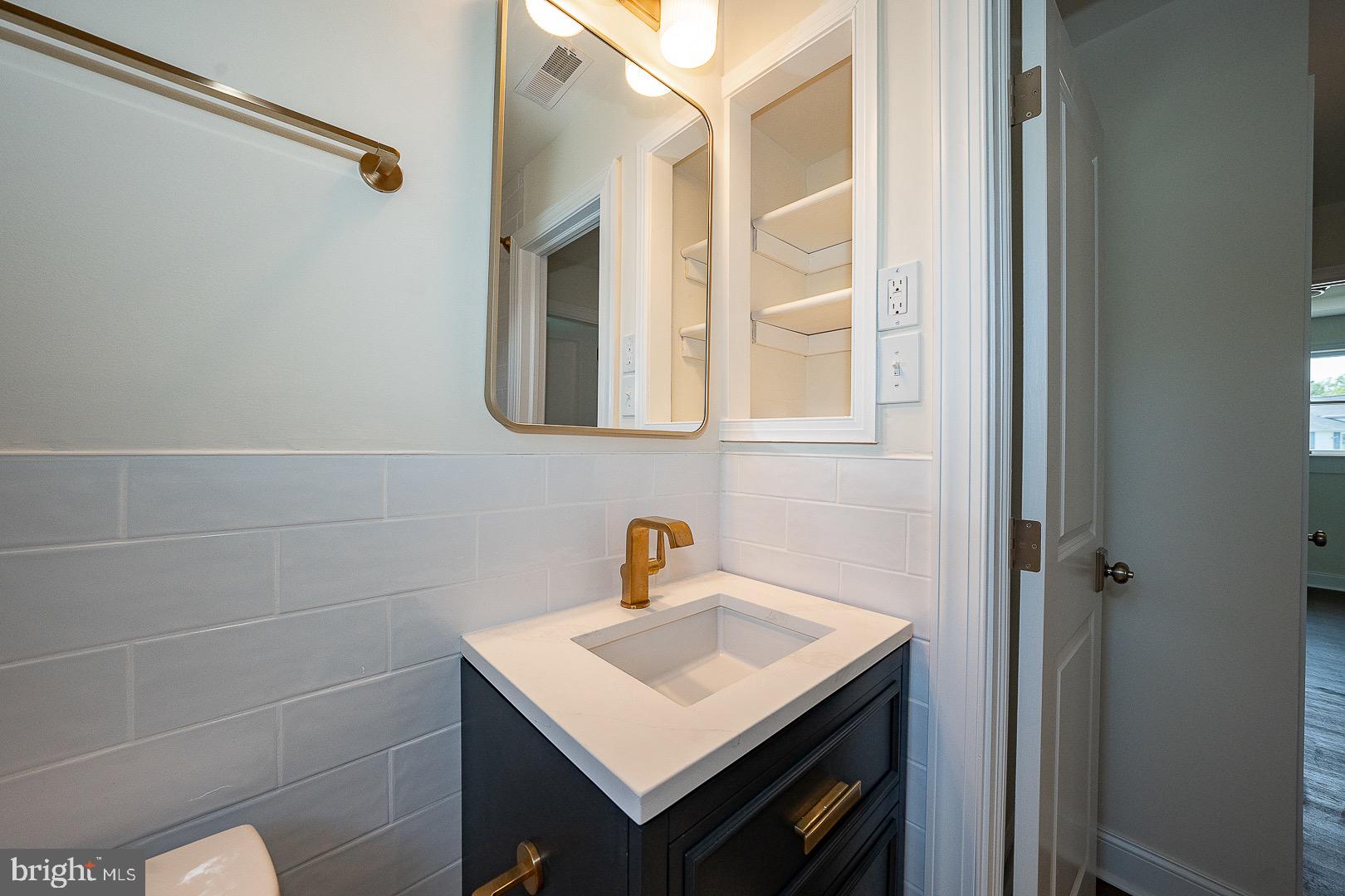 503 Poplar Road Flourtown, PA 19031 - Photo 33 of 63 a bathroom with a sink a vanity and a mirror