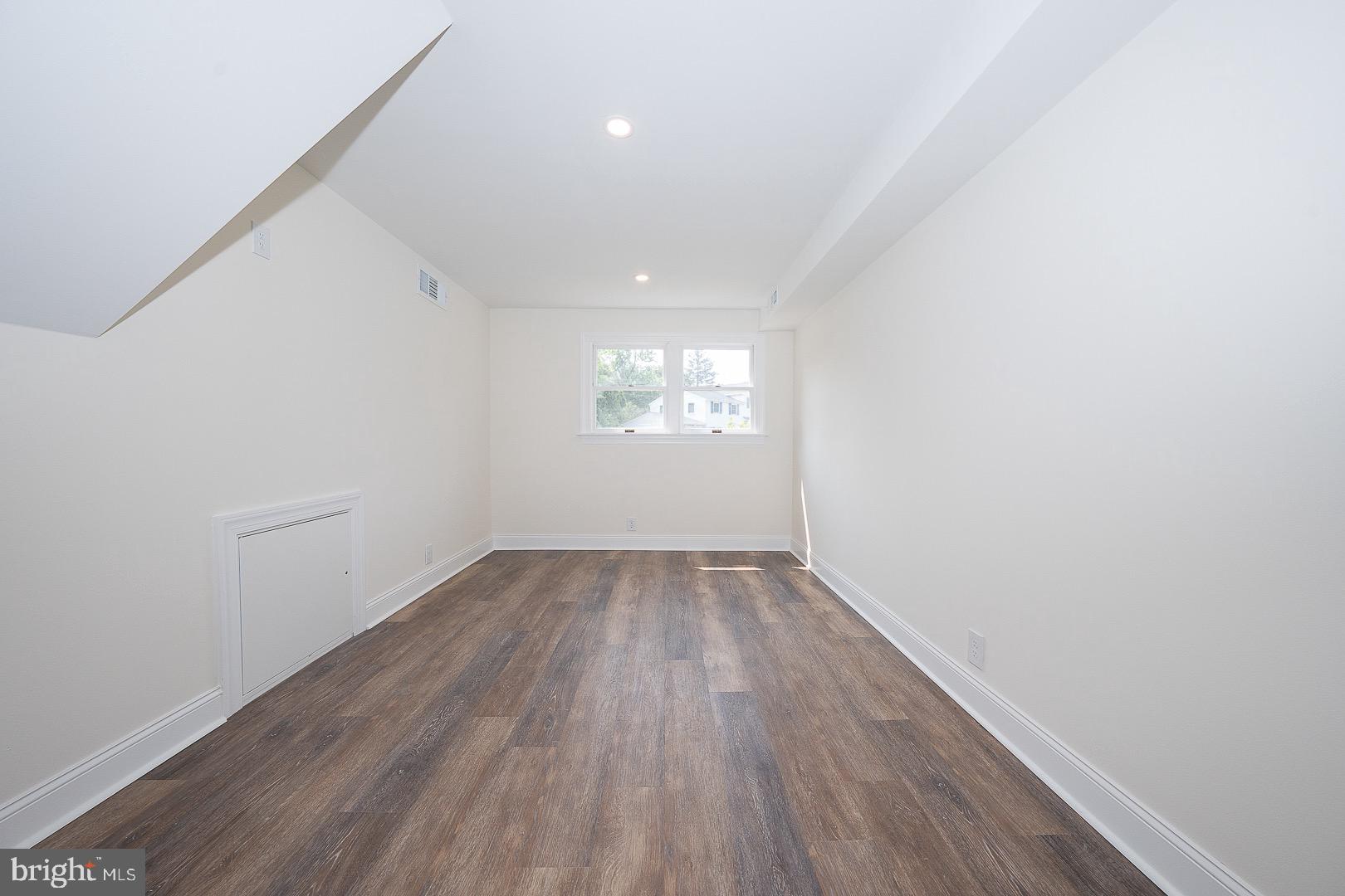 503 Poplar Road Flourtown, PA 19031 - Photo 45 of 63 an empty room with wooden floor and windows