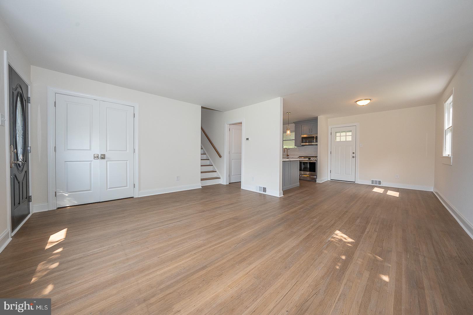 503 Poplar Road Flourtown, PA 19031 - Photo 9 of 63 a view of empty room with wooden floor and kitchen
