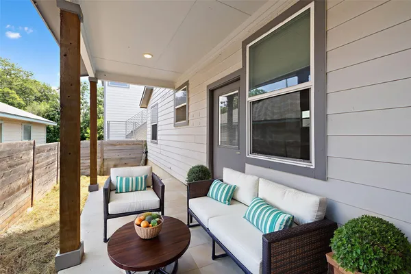 a balcony with furniture and a potted plant