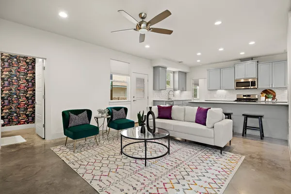 a living room with furniture and kitchen view
