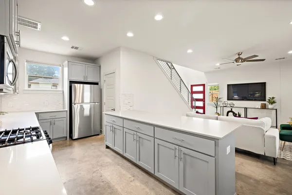 a kitchen with refrigerator and cabinets