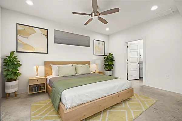 a bedroom with a bed and a potted plant