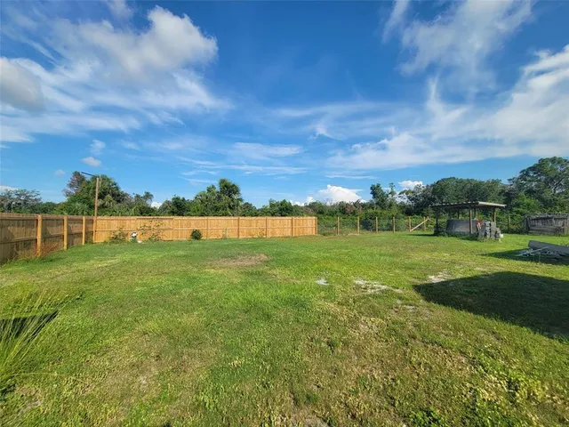 a view of grassy field with building in background