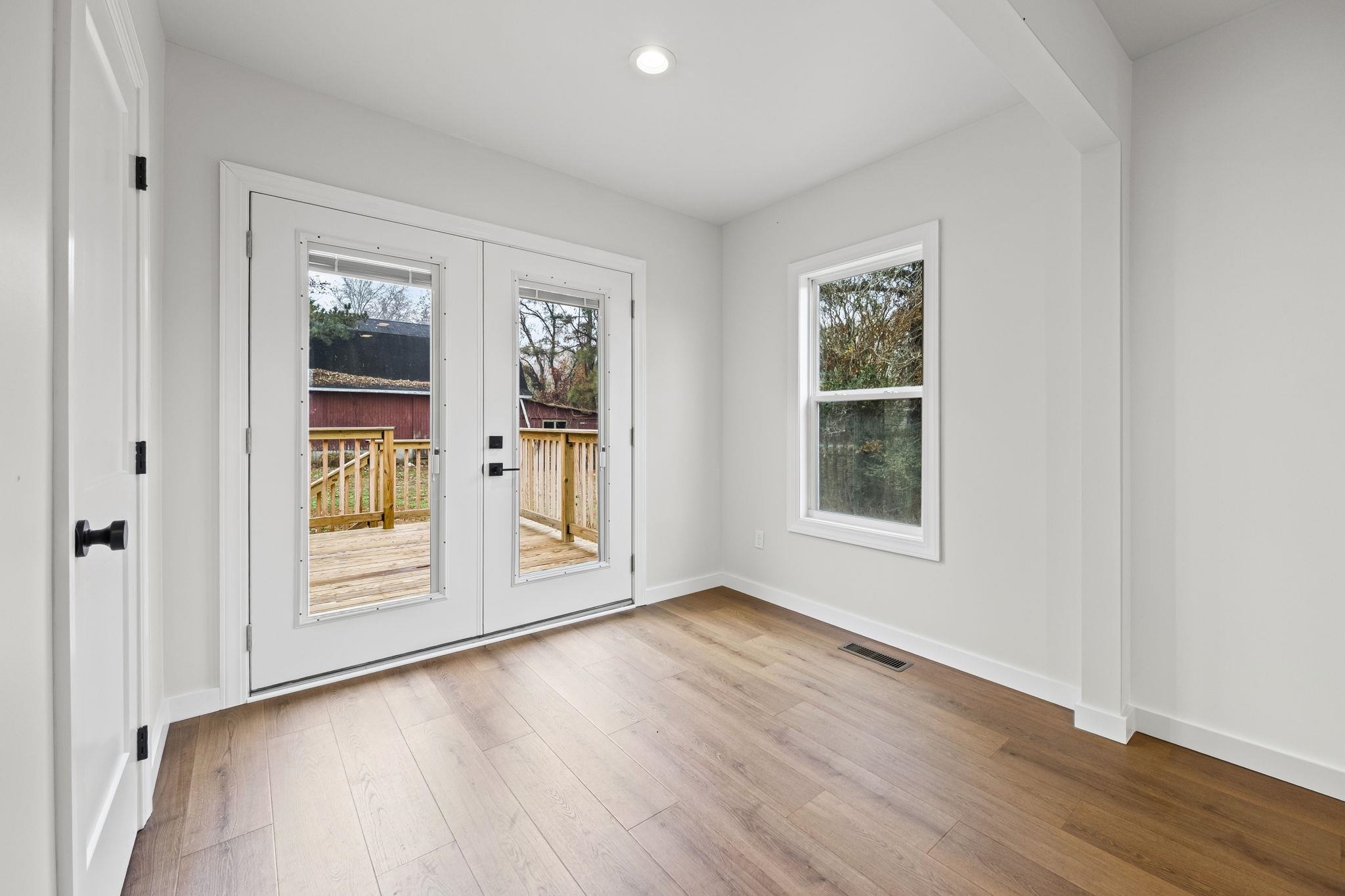 835 Curve Woodville Road Gates, TN 38037 - Photo 13 of 33 a view of an empty room with wooden floor and a window