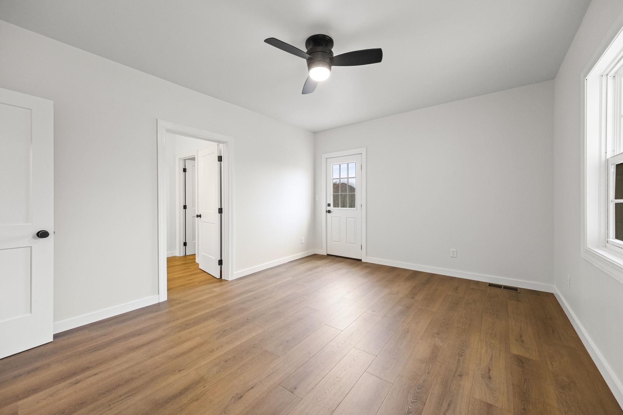 835 Curve Woodville Road Gates, TN 38037 - Photo 15 of 33 an empty room with wooden floor and ceiling fan